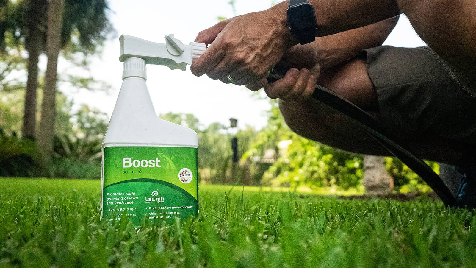 Lawnifi Boost Bottle Connecting To Hose On Grass Lawn
